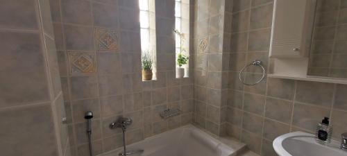 a bathroom with a bath tub and a sink at Harmony 3 in Artemida