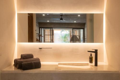a bathroom with a sink and a mirror at Jiloo- Beautiful Oasis in Punta Zicatela 7 in Brisas de Zicatela