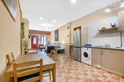 a kitchen with a table and a dining room at Planta Baja al al lado de Playa Arenas in Valencia