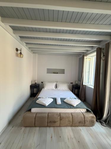 a bedroom with a large bed in a room at Gorgeous restored house at Platanos square in Lésvos