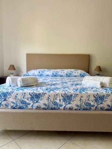 a blue and white bed with two pillows on it at Heliomar Naxos - Your Balcony on the Sea in Giardini Naxos