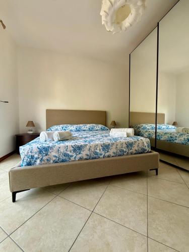 a bedroom with two beds and a large mirror at Heliomar Naxos - Your Balcony on the Sea in Giardini Naxos