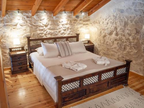 a bedroom with a bed with two towels on it at Arcus Suites in Argyroupolis