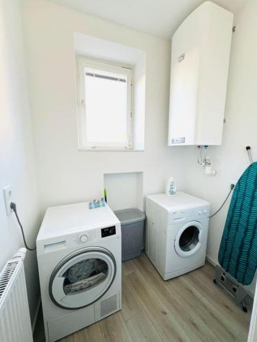a laundry room with a washing machine and a washer at Leoben Top 6 in Leitendorf