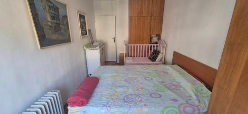 a small bedroom with a bed and a crib at Herceg Novi, Topla, 10 min from the sea in Španjola