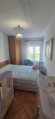 a bedroom with a large bed and a window at Herceg Novi, Topla, 10 min from the sea in Španjola