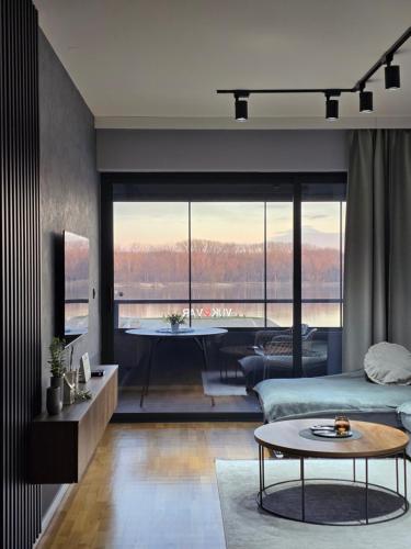 a living room with a bed and a table and a tub at Goreta032 Luxury Apartment 2 in Vukovar