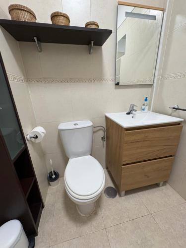 a bathroom with a white toilet and a sink at Apartamento La Marquesa Beach in Puertito de Güímar