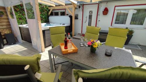 a patio with a table and chairs and a kitchen at Ferienhaus Gabriela Allgäu in Immenstadt im Allgäu
