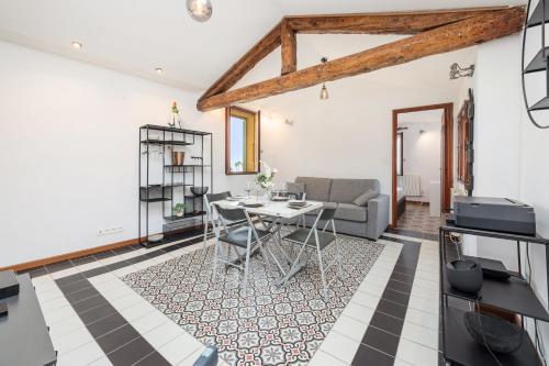 a living room with a table and a couch at Bastion Ideally located, brightness, sea views in Menton