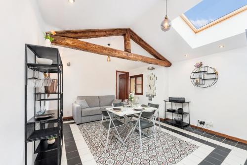 a living room with a table and a couch at Bastion Ideally located, brightness, sea views in Menton