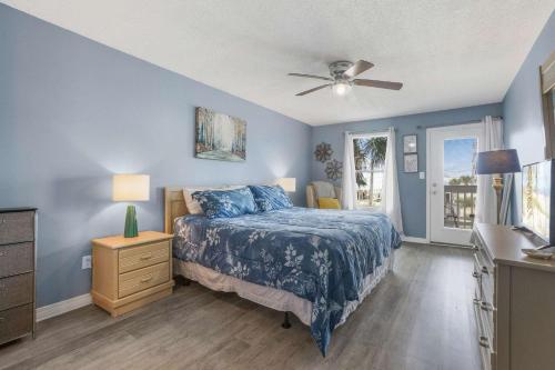 a bedroom with a bed and a ceiling fan at Sea Oats 102C- Beach view Pool 25 steps to beach in Gulf Shores