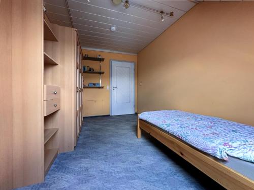a bedroom with a bed and a closet at Zur Gradlhöhe in Dietersdorf