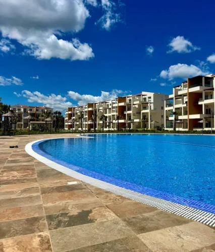 a swimming pool in front of some apartment buildings at Location appart in Cabo Negro
