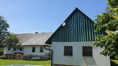 a white house with a black and white roof at Chalupa Jestřebí in Velké Svatoňovice