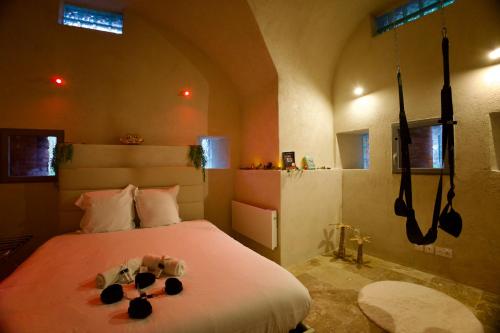 a bedroom with a bed with two teddy bears on it at Les Secrets du Fort - Love Room unique in Albertville