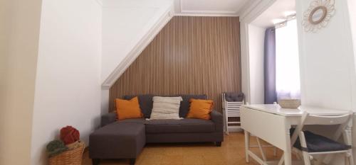 a living room with a couch and a table at Casa Pisa Flores - Praia da Nazaré in Nazaré
