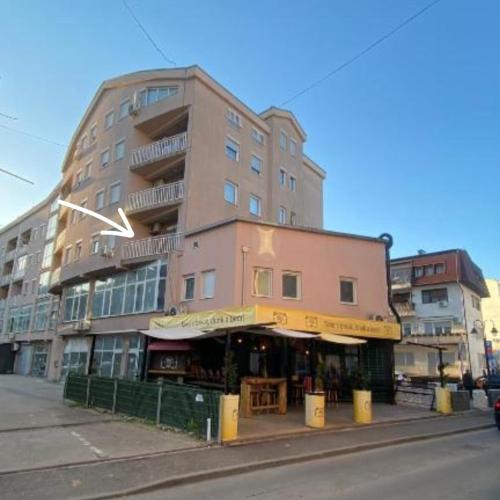 un edificio alto con una tienda delante en Apartman Gold King, en Brčko