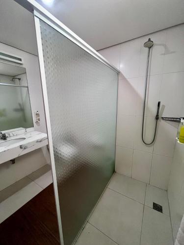 a shower with a glass door in a bathroom at Atibaia Residence Hotel & Resort in Atibaia