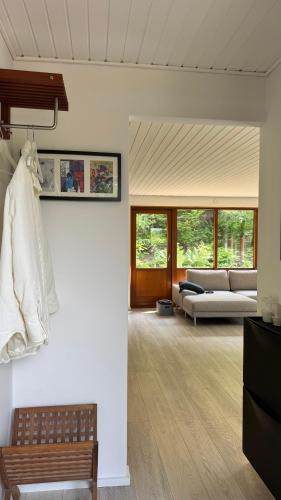 a living room with a couch and a bench at Melby-Liseleje-Frederiksværk in Melby