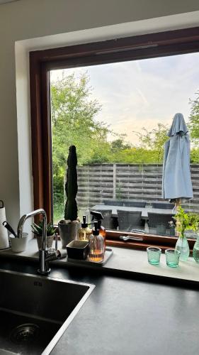 a kitchen counter with a sink and a window at Melby-Liseleje-Frederiksværk in Melby