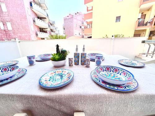 a table with blue and white plates on it at Quadrilocale vista mare completamente climatizzato in Gallipoli