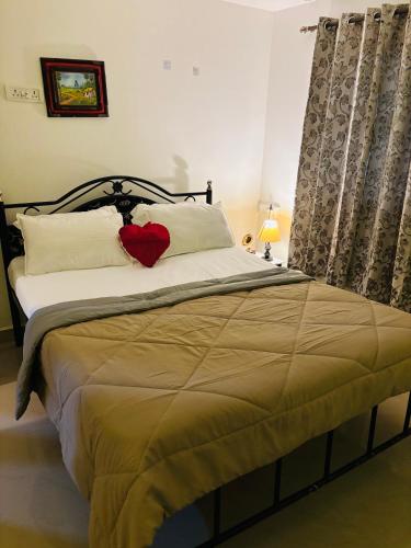 a bedroom with a bed with a red heart on it at Hidden Gem agonda in Agonda