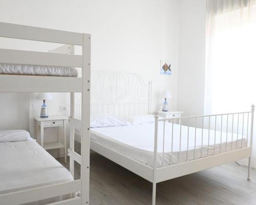 a white bunk bed in a white bedroom at S270 - Sirolo, quadrilocale in centro con vista panoramica in Sirolo