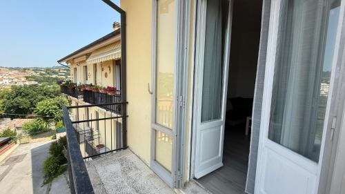 an open door to a balcony with a view at S270 - Sirolo, quadrilocale in centro con vista panoramica in Sirolo