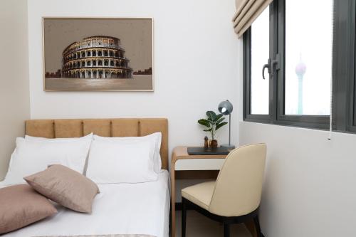 a bedroom with a bed and a desk with a chair at Trizen Colombo Luxury 3BR Smart Apartment with Breathtaking Views & Designer Furnishings in Colombo