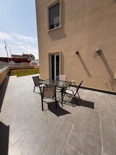 a patio with a table and chairs on a building at Casa Florean in Cicciano