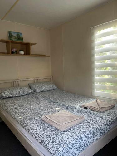 a bedroom with a bed with two towels on it at Riviera Zator in Zator