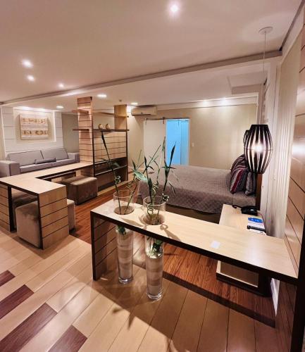 a bedroom with a bed and a living room at Atibaia Residence Hotel & Resort in Atibaia