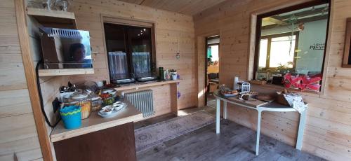 a room with a table and a television in a cabin at Haus Sieben - Singer Lydia in Kötschach