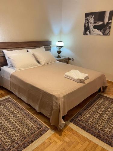 a bedroom with a large bed with a lamp at Aelia Seaside Maisonette in Neoi Epivates