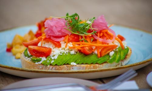 a sandwich with vegetables on a plate on a table at B Ocean Resort Fort Lauderdale Beach in Fort Lauderdale