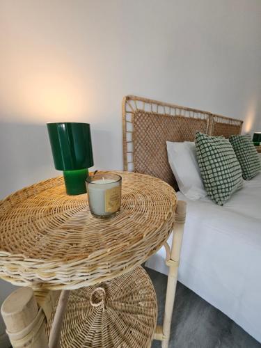 a rattan table with a green cup on top of a bed at Estoril House in Estoril