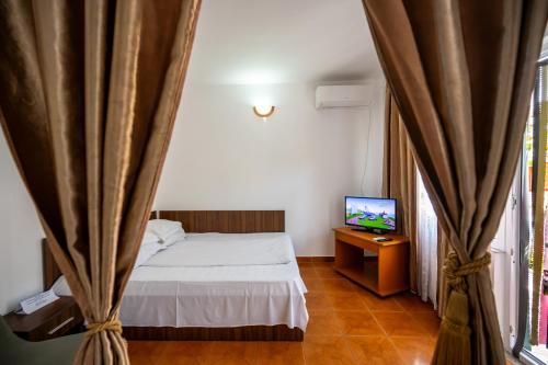 En eller flere senge i et værelse på Casa Amalia