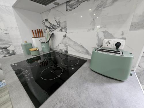 a kitchen with a stove and a counter top at Estoril House in Estoril