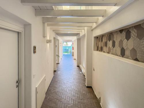 a corridor of a building with a long hallway at Aras Hotel Boutique in Villasimius