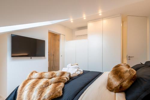 Un dormitorio con una cama con almohadas cubiertas de piel. en Sunny Duplex with Pool and Ofir Beach Nature Escape, en Fão