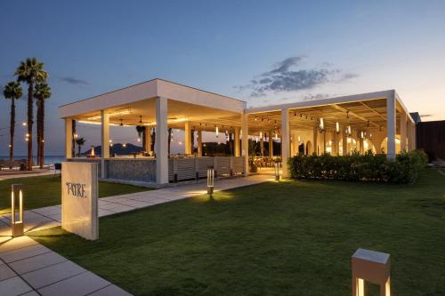 a large building with lights on the grass at Liberty Signa in Fethiye