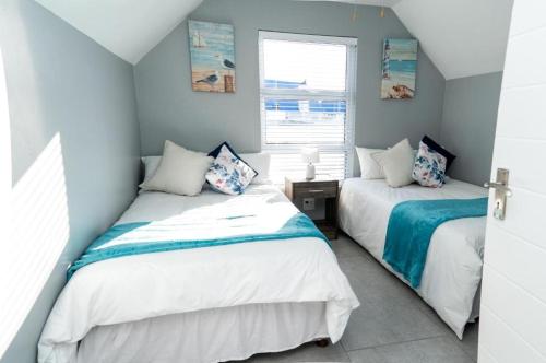 Ένα ή περισσότερα κρεβάτια σε δωμάτιο στο Starfish Cottage