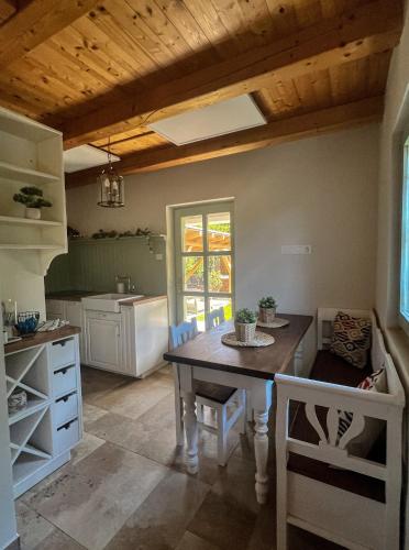 a kitchen with a table and chairs in a room at Zanzara Guesthouse in Pákozd