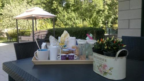 a table with a tray with flowers and cups on it at B&B Villa Verde in Pesche