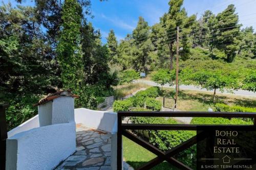 a gate with a sign that reads bior real estate at Casa Calma Beachfront 3bdrm Maisonette in Mola Kalyva