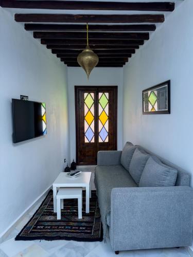 a living room with a couch and a table at Maison Mouna in Tangier
