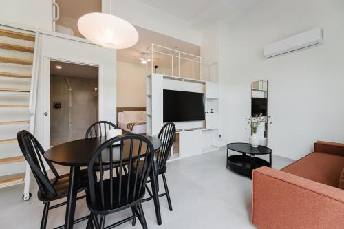 a dining room and living room with a table and chairs at Gran Turia Apartments in Valencia