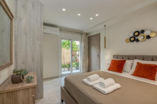 a bedroom with a large bed with towels on it at Garden House 2 in Kissamos