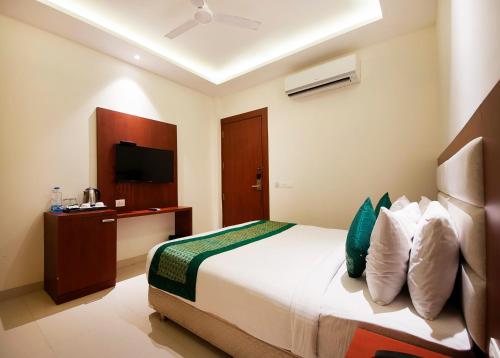 a hotel room with a bed and a television at Hotel Z Suites - Delhi Airport- FREE Airport Pickup & Drop in New Delhi
